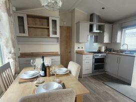A kitchen with a dining table set at Beachside Lodge - Sleeps 6 - Pets ok - Parking, Heysham