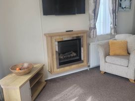 A living room with a television and a fireplace at Beachside Lodge - Sleeps 6 - Pets ok - Parking in Heysham