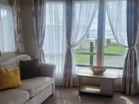 A living room with a sofa and table at Beachside Lodge - Sleeps 6 - Pets ok - Parking Heysham