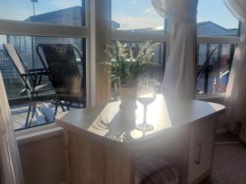 A snug area with a table and glass at Beachside Lodge - Sleeps 6 - Pets ok - Parking in Heysham