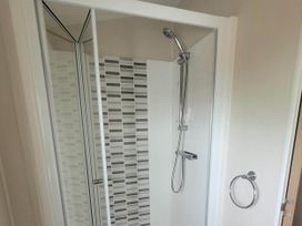 A shower with glass door and wall tiles at Beachside Lodge - Sleeps 6 - Pets ok - Parking Heysham