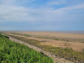 A beach with sand and water at Beachside Lodge - Sleeps 6 - Pets ok - Parking in Heysham