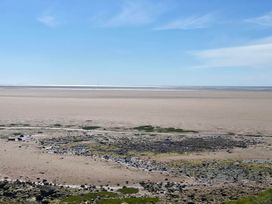 A beach with rocks and tidal water at Beachside Lodge - Sleeps 6 - Pets ok - Parking in Heysham