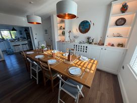 A dining room with a table set for meals at Lorrell in Salcombe