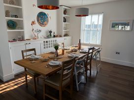 A dining room with a set table and decorative items at Lorrell in Salcombe