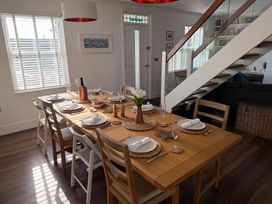A dining room with a table set for dining at Lorrell in Salcombe