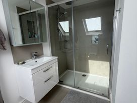 A bathroom with a shower and sink at Lorrell in Salcombe
