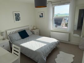 A bedroom with a bed and desk at Lorrell in Salcombe