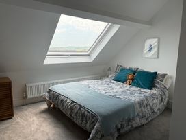 A bedroom with a bed and window at Lorrell in Salcombe