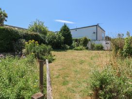 A garden with grass and flowers at Lorrell in Salcombe