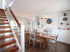 A dining room with a table and chairs at Lorrell in Salcombe