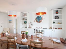 A dining room with a table set for dinner at Lorrell in Salcombe