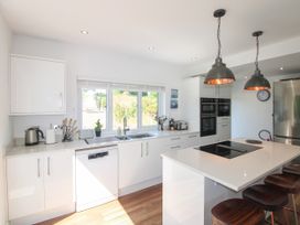 A kitchen with a sink and appliances at Lorrell in Salcombe