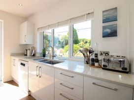 A kitchen with a sink and a dishwasher at Lorrell in Salcombe