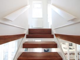 A staircase with wooden steps and a handrail at Lorrell in Salcombe