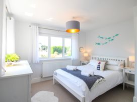 A bedroom with a bed and bedside tables at Lorrell in Salcombe