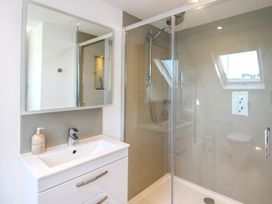 A bathroom with a sink and shower at Lorrell in Salcombe