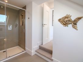 A bathroom with a shower and a fish decoration at Lorrell in Salcombe