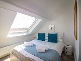 A bedroom with a bed and window at Lorrell in Salcombe