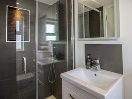 A bathroom with a shower and sink at Lorrell in Salcombe