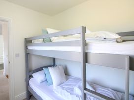 A bunk bed with pillows and towels at Lorrell in Salcombe