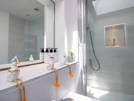 A bathroom with a shower and decorative items at Lorrell in Salcombe