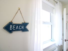 A beach sign and a window in an interior space at Lorrell Salcombe