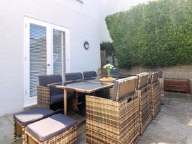 An outdoor dining area with a table and chairs at Lorrell in Salcombe