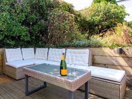 An outdoor seating area with a sofa and a table at Lorrell in Salcombe