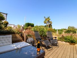 An outdoor space with a couch and table at Lorrell in Salcombe