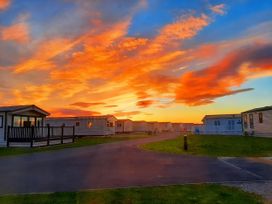 A pathway with caravans at Taid's Retreat Silversands Cove beach lossiemouth