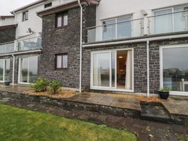 An outdoor area with a patio, plants, and sliding doors at 10 Oakley Wharf Porthmadog