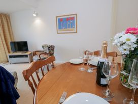 A dining room with a table set for a meal at 10 Oakley Wharf Porthmadog
