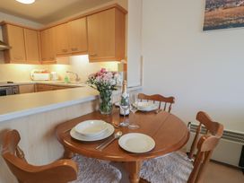 A dining room with a table and chairs at 10 Oakley Wharf in Porthmadog