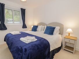 A bedroom with a double bed and bedside table at 10 Oakley Wharf Porthmadog