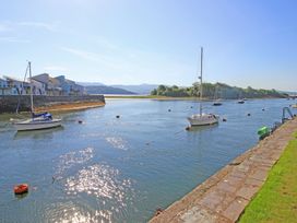 A view of boats on a river with houses in the background at 10 Oakley Wharf Porthmadog