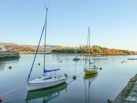Boats on a river surrounded by mountains at 10 Oakley Wharf Porthmadog