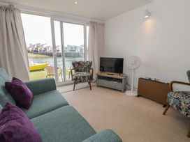 A living room with a sofa and television at Harbourside in Porthmadog