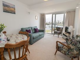 A living room with a sofa and dining table at Harbourside in Porthmadog