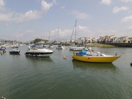 A marina with boats and houses at Harbourside in Porthmadog