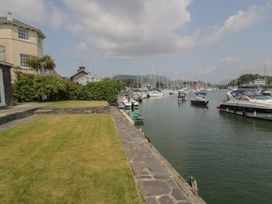 A view of the marina with boats and grass at Harbourside in Porthmadog