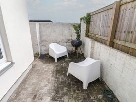 An outdoor area with two chairs and a barbecue at Kiloran in Rhosneigr