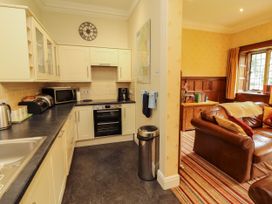 A kitchen with appliances and furniture at Rochester Apartment in Orton
