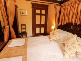 A bedroom with a bed and a chair at Rochester Apartment in Orton