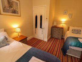 A bedroom with two beds and a dresser at Rochester Apartment in Orton