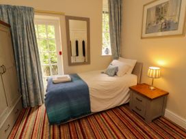 A bedroom with a single bed and window at Rochester Apartment in Orton