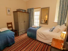 A bedroom with two beds and a wardrobe at Rochester Apartment in Orton