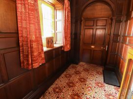 A hallway with wood paneling and a window at Rochester Apartment in Orton