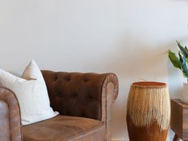 A living room with a sofa and drum at Anchors Rest in St. Ives