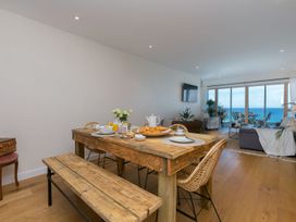 A dining room with a wooden table and chairs at Anchors Rest in St. Ives